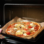 taking pizza out use parchment paper