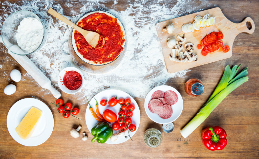  pizza ingredients, tomatoes, salami and mushrooms 