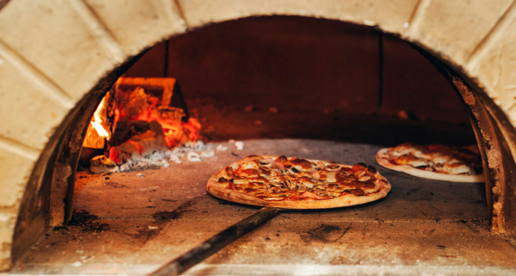 Number of pizza is cooked in a wood-fired oven