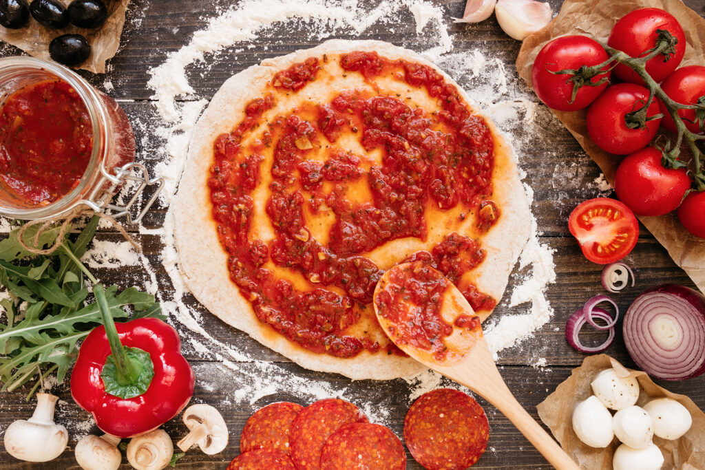 fresh tomato sauce to pizza dough