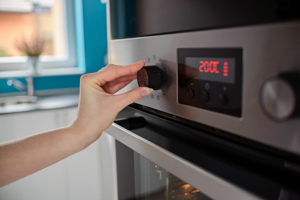 woman regulates temperature oven