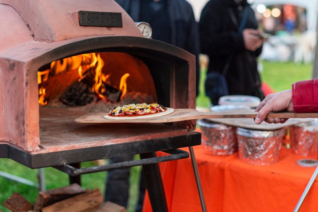 Outdoor Pizza oven with flames on a garden