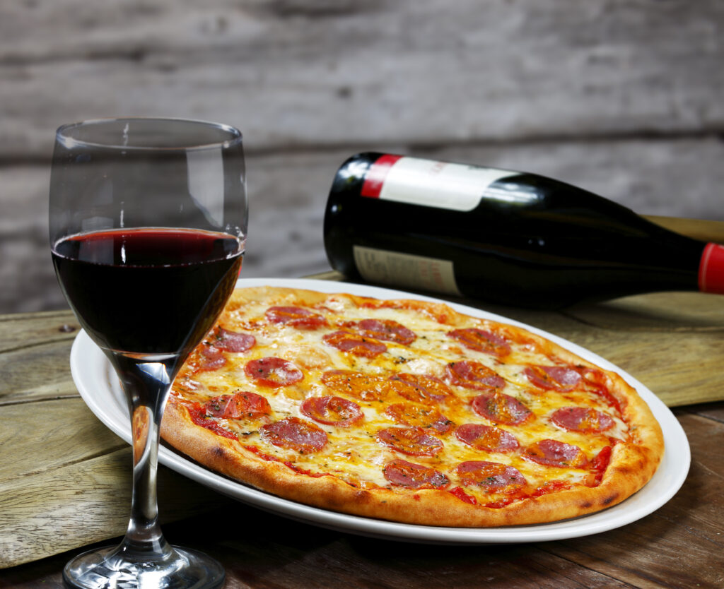 Dinner with wine and pepperoni  pizza