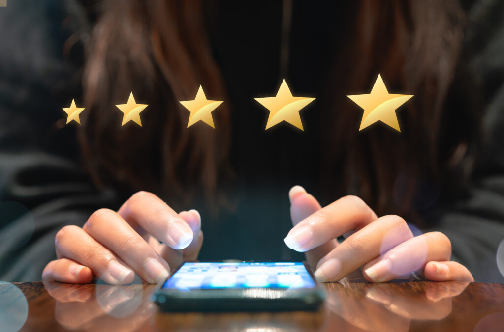 Woman filling out 5 star gold customer service feedback survey on electronic mobile device