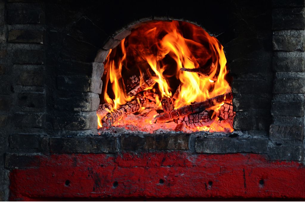 pizza oven lighting the wood