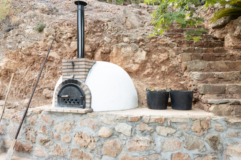 White painted artisan wood oven with door  built outside