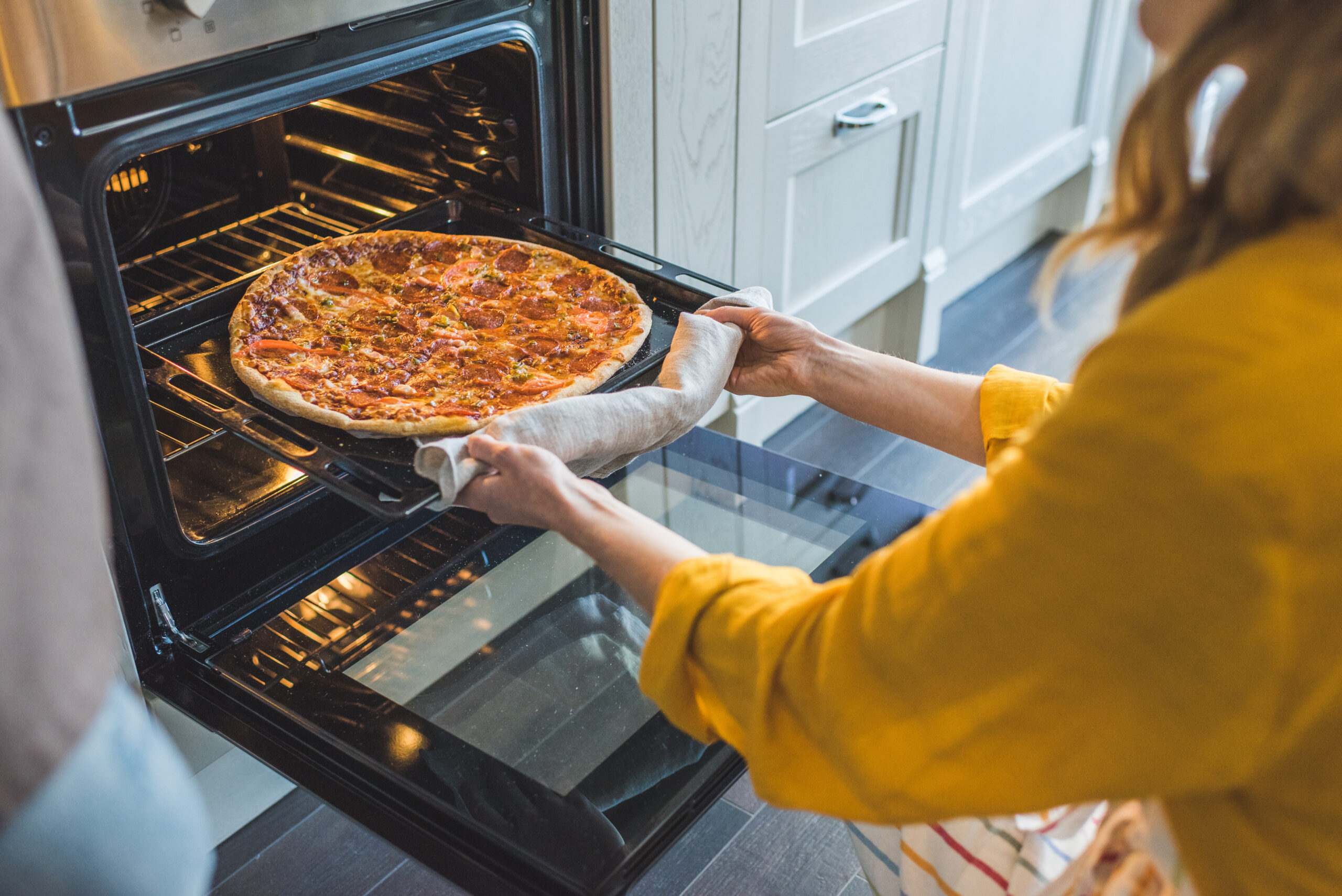 woman cooking a pizza